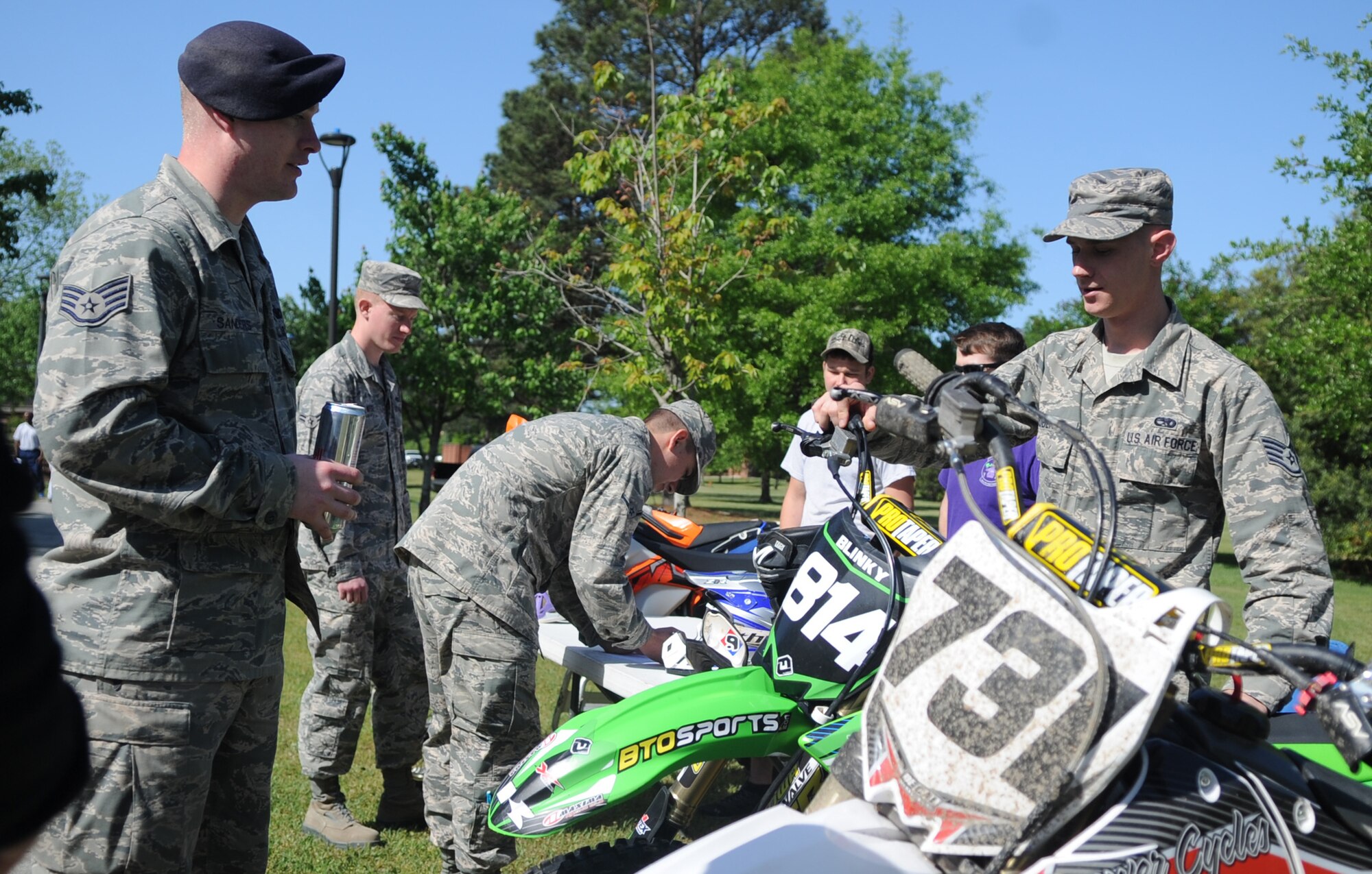 Staff Sgt. Blaine Roberts (right), 4th Component Maintenance Squadron hydraulic systems technician, shows off his Kawasaki KX 250F to an Airman during a Club Day event, April 24, 2015, at Seymour Johnson Air Force Base, North Carolina. Roberts is a member of the base’s Dirtbike Club, one of more than 70 clubs on base. (U.S. Air Force photo/Senior Airman Ashley J. Thum)