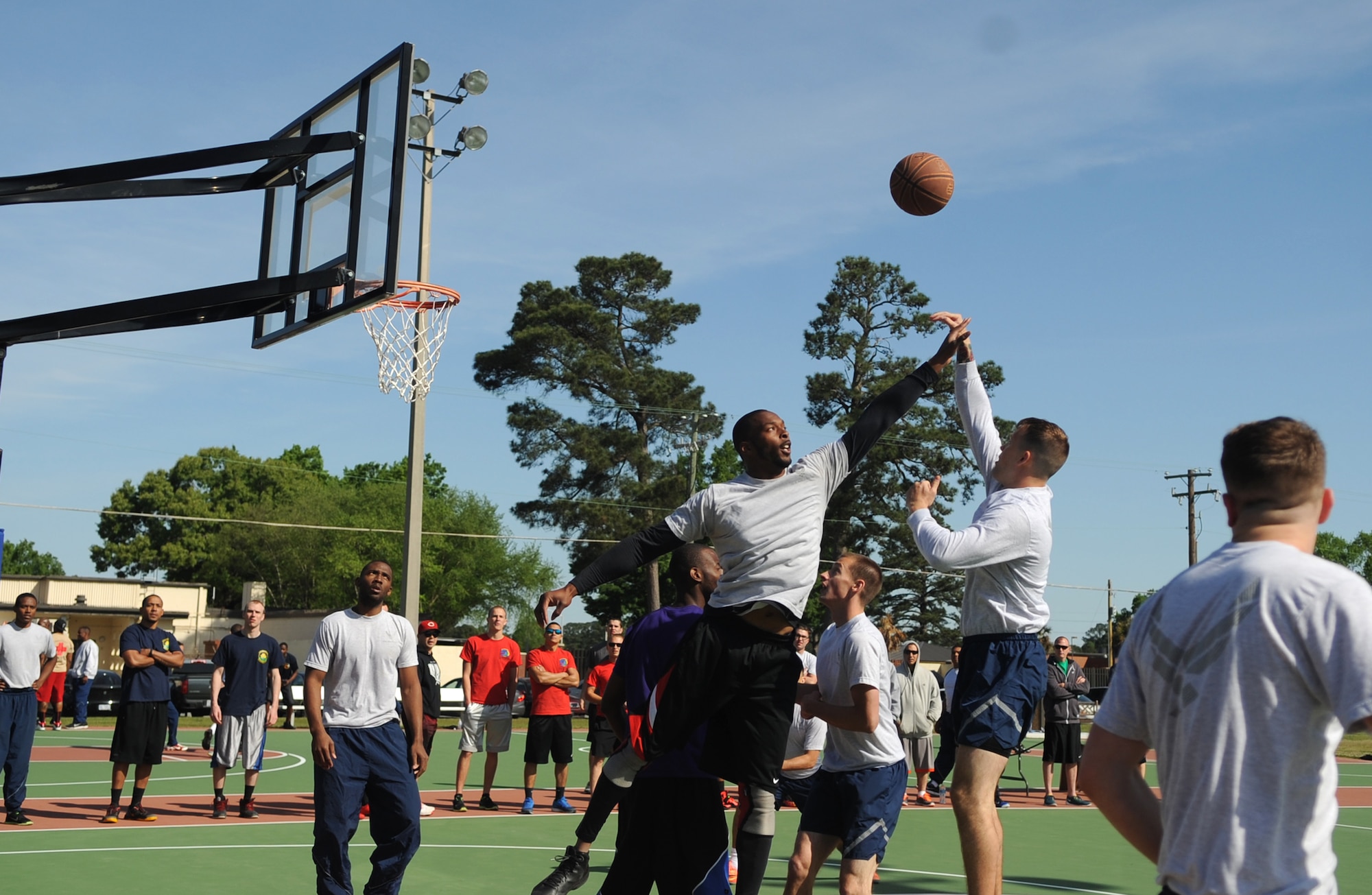 An Airman from the 4th Maintenance Group attempts to block the shot of an Airman from the 4th Operations Support Squadron as part of the squadron sports challenge during a Club Day event, April 24, 2015, at Seymour Johnson Air Force Base, North Carolina. The squadron sports challenge also featured kickball, volleyball and other athletic activities. (U.S. Air Force photo/Senior Airman Ashley J. Thum) 