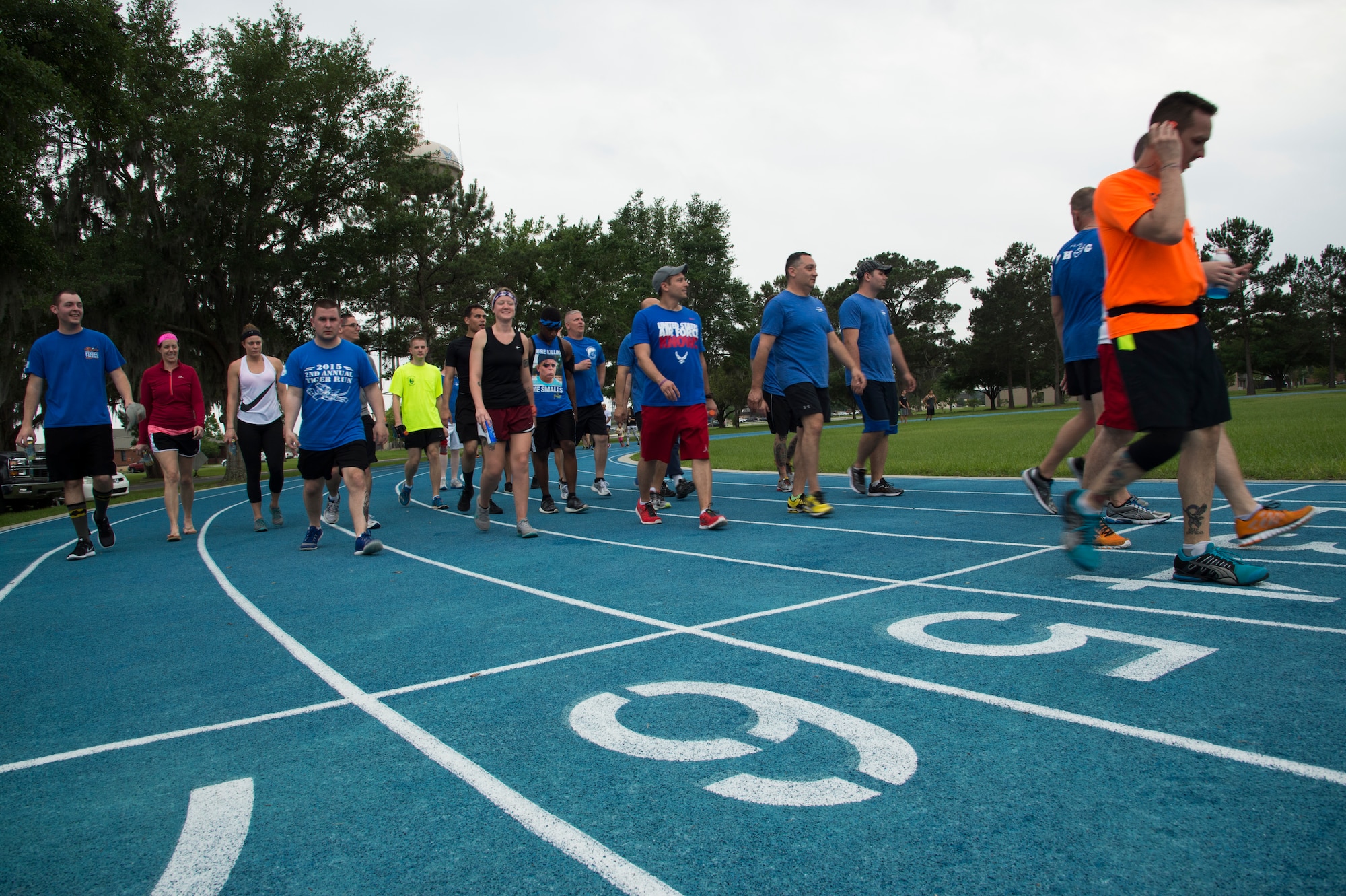 Participants in the Air Force Sergeants Association Chapter 460 2nd Annual Tiger Run walk the final lap before completing a 12-hour marathon team run to raise donations for the Air Force Assistance Fund April 25, 2015, at Moody Air Force Base, Ga. The combined participants ran more than 1,250 miles and raised more than $3,133 in donations. (U.S. Air Force photo by Staff Sgt. Eric Summers Jr./ Released)