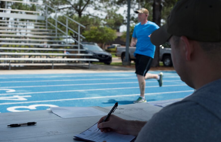 Airman 1st Class Noah Carpenter, 23d Operations Support Squadron, tracks runners as they pass by the rankings stand during the Air Force Sergeants Association Chapter 460 2nd Annual Tiger Run April 25, 2015, at Moody Air Force Base, Ga. The combined total of miles ran by the teams was more than 1,250 miles. (U.S. Air Force photo by Staff Sgt. Eric Summers Jr./ Released)