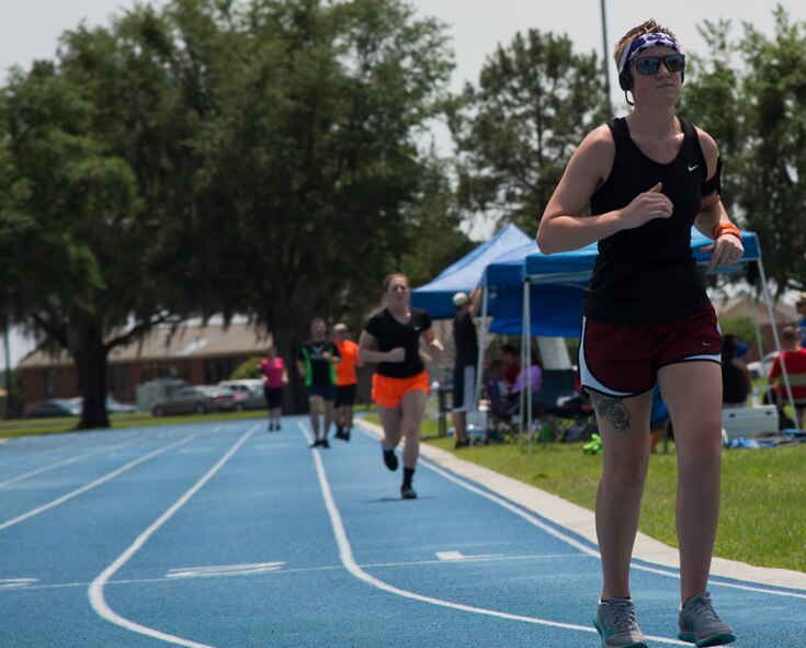 Staff Sgt. Jamie Corbin, 23d Maintenance Operations Flight, rounds the curve of the track during the Air Force Sergeants Association Chapter 460 2nd Annual Tiger Run April 25, 2015, Moody Air Force Base, Ga. The run was held to raise donations for the Air Force Enlisted Village. (U.S. Air Force photo by Staff Sgt. Eric Summers Jr./Released)