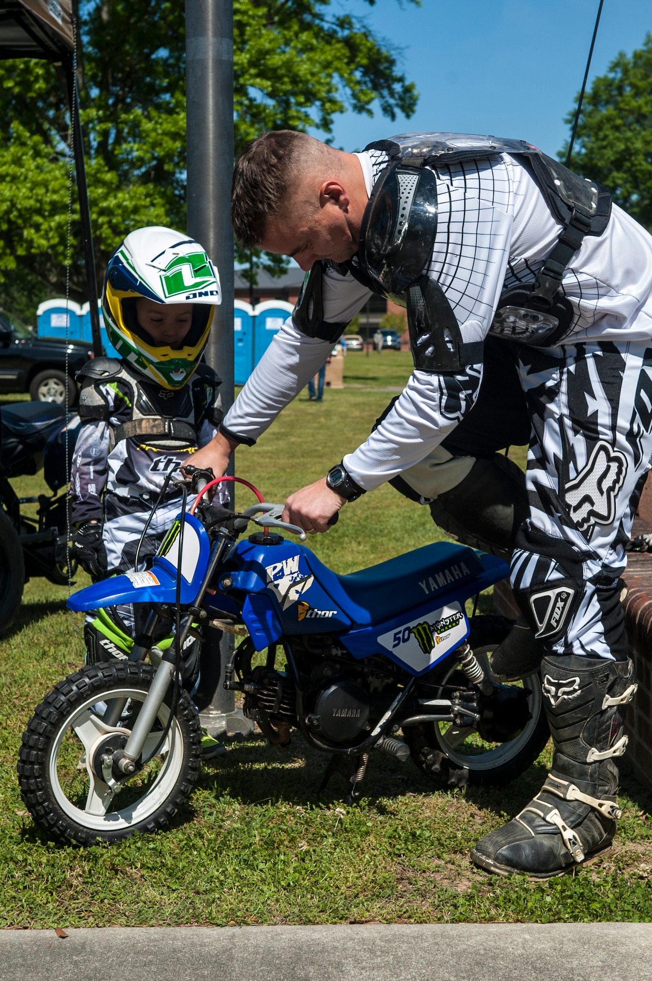 Maj. Zachary Mellor, 334th Fighter Squadron assistant director of operations, starts a bike for his child during Club Day, April 24, 2015, at Seymour Johnson Air Force Base, North Carolina. The All-Terrain Club has the most members of all the clubs offered at Seymour Johnson AFB and accepts members of all ages. (U.S. Air Force photo/Airman Shawna L. Keyes)