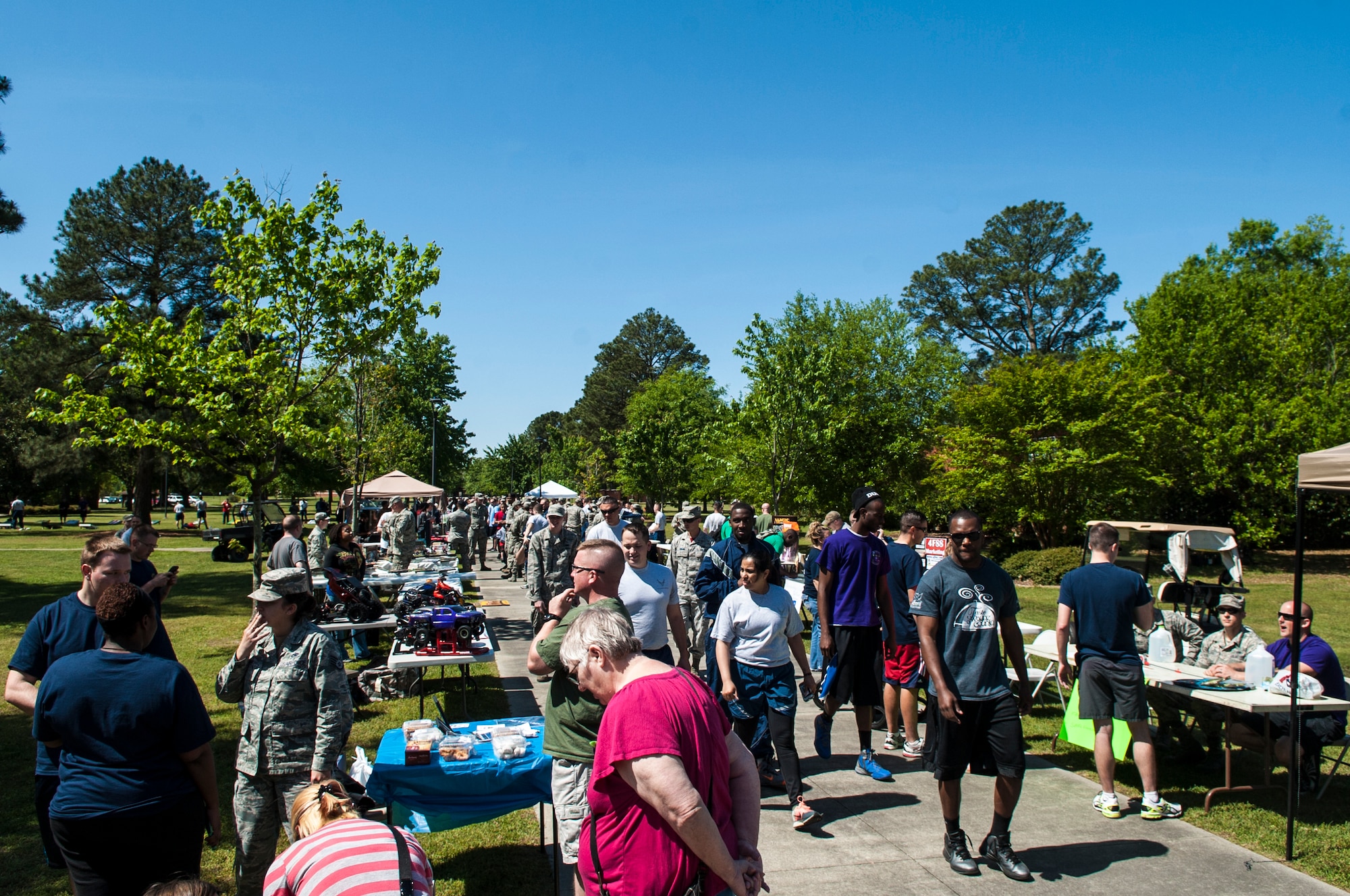 Airmen and their families check out different activities during Club Day, April 24, 2015, at Seymour Johnson Air Force Base, North Carolina. More than 20 clubs were featured “in action” to promote interest in the activities offered on base and help increase morale. (U.S. Air Force photo/Airman Shawna L. Keyes)