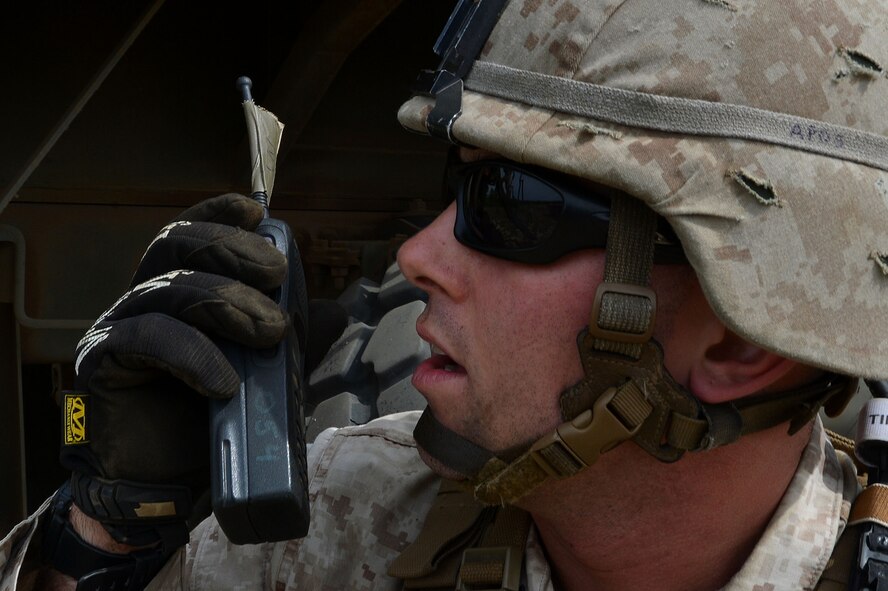 A U.S. Marine assigned to the Marine Wing Support Squadron 273, Motor Transportation Company, Marine Corps Air Station Beaufort, S.C., uses his radio to report a simulated roadside bomb explosion at Poinsett Electronic Combat Range, Wedgefield, S.C., April 23, 2015. While at Poinsett, the Marines set up a "tent city" and spent four nights sleeping there. (U.S. Air Force photo by Airman 1st Class Michael Cossaboom/Released)   
