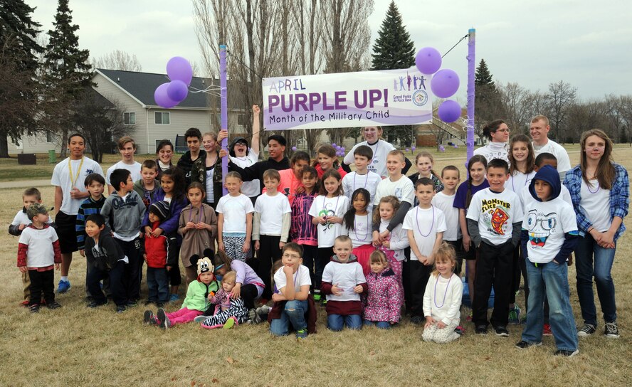 Children from the Nathan Twining Elementary/Middle School participated in the Purple Up! run to promote the Month of the Military Child April 24, 2015, on Grand Forks Air Force Base, N.D. The children and parents ran two miles total while being doused in purple powder. (U.S. Air Force Photo by Senior Airman Zachiah Roberson/Released)