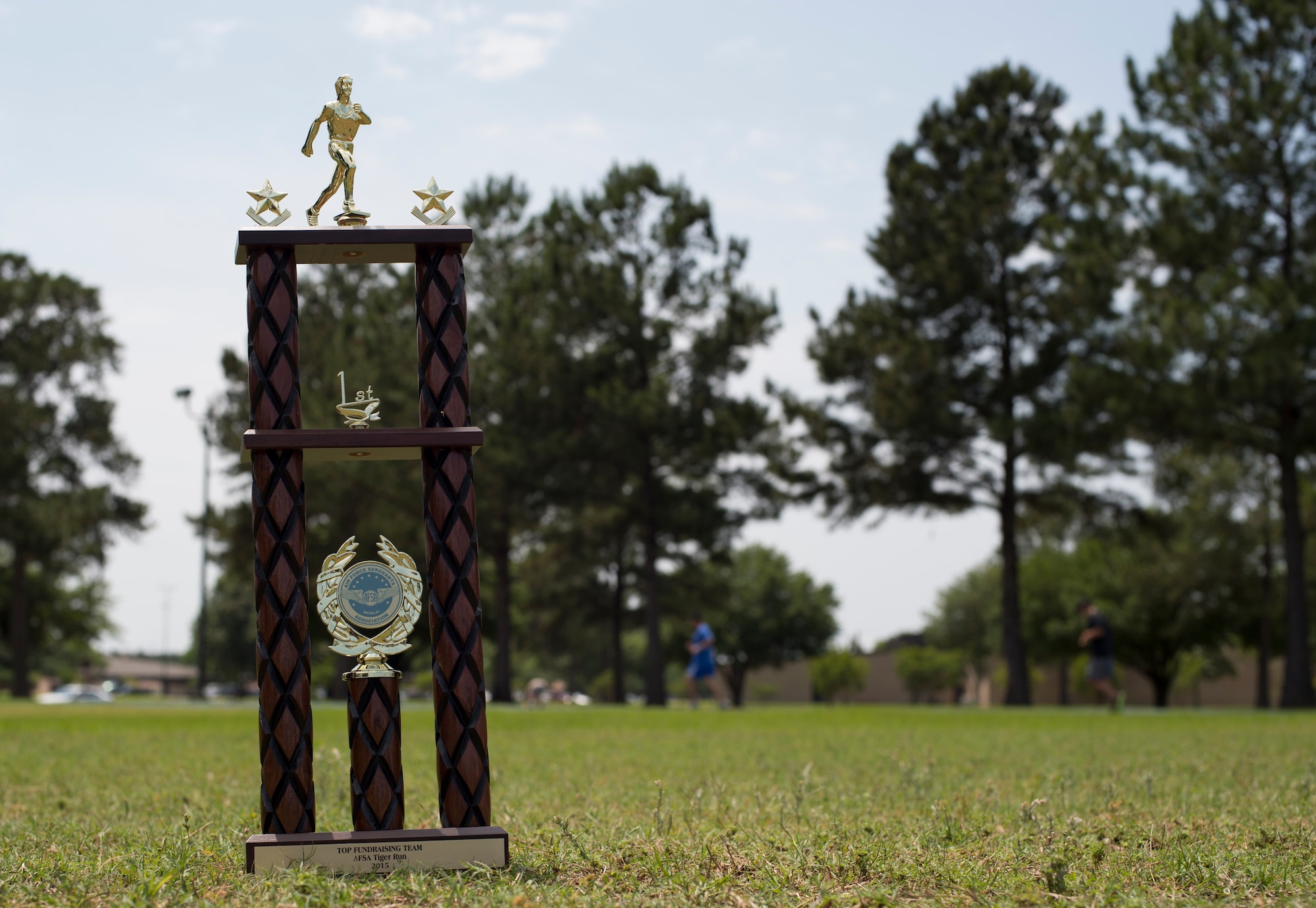 The Air Force Sergeants Association Chapter 460 2nd Annual Tiger Run first place trophy sits displayed as participants continue to run laps April 25, 2015, at Moody Air Force Base, Ga. The 822d Base Defense Squadron won first place and broke last year’s record by running a total of more than 112 miles in the 12-hour time span. (U.S. Air Force photo by Staff Sgt. Eric Summers Jr./Released)