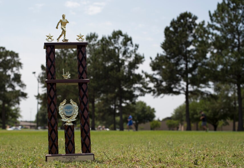 The Air Force Sergeants Association Chapter 460 2nd Annual Tiger Run first place trophy sits displayed as participants continue to run laps April 25, 2015, at Moody Air Force Base, Ga. The 822d Base Defense Squadron won first place and broke last year’s record by running a total of more than 112 miles in the 12-hour time span. (U.S. Air Force photo by Staff Sgt. Eric Summers Jr./Released)