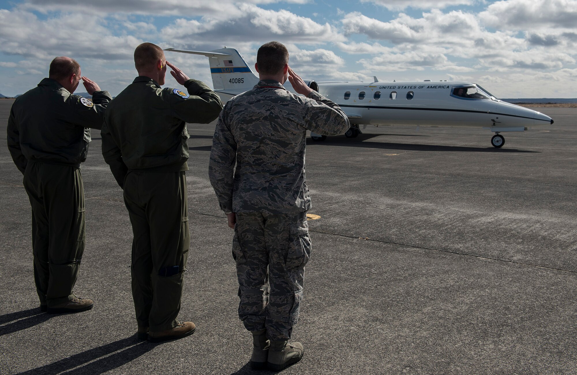 Leaders from the 871st Air Expeditionary Squadron salute a plane carrying U.S. Air Force Lt. Gen. Darryl Roberson, 3rd AF commander, U.S. Air Force Chief Master Sgt. Kaleth Wright, 3rd Air Force command chief, U.S. Air Force Col. Robert Navotny, 48th Fighter Wing commander, and U.S. Air Force Col. Kenneth Bibb, Jr., 100th Air Refueling Wing commander, as it departs Keflavik International Airport, Iceland, after visiting deployed members supporting the Icelandic Air Surveillance and Policing mission April 23, 2015. The IAS mission, an ongoing NATO commitment to maintain the security of Iceland’s airspace, is supported on a rotational basis by fighter aircraft units throughout NATO nations. (U.S. Air Force photo by Staff Sgt. Chad Warren/Released)
