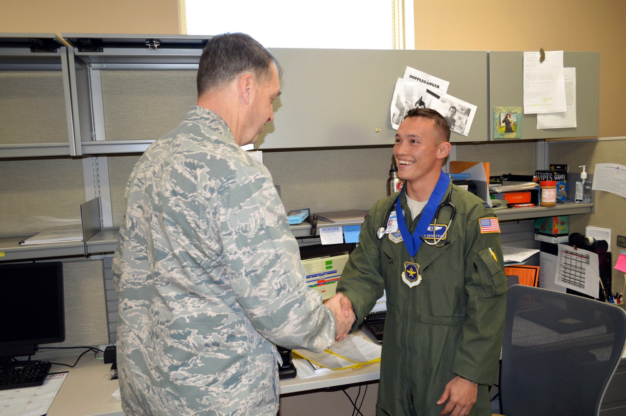 Brig. Gen. Kory Cornum, Air Mobility Command surgeon, presents the Air Mobility Command ‘Real Pro’ Award to Capt. Richard Grinstead, 43rd Medical Squadron, recognizing Grinstead’s outstanding duty performance during his visit to the 43rd Airlift Group on Apr. 22, Pope Army Airfield, N.C. (U.S. Air Force photo/Marvin Krause)