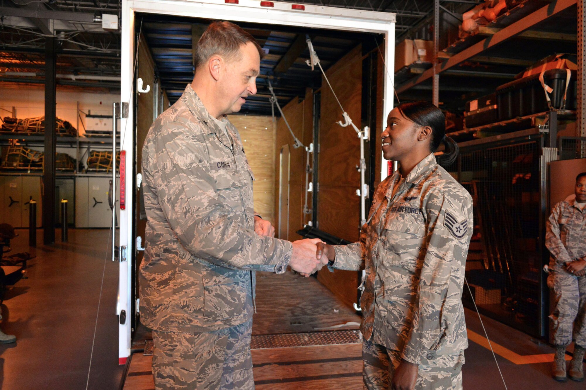 Brig. Gen. Kory Cornum, Air Mobility Command surgeon, presents his commander’s coin to Staff Sgt. Banita Hines, 43rd Aeromedical Evacuation Squadron, recognizing Hines’ outstanding duty performance during his visit to the 43rd Airlift Group on Apr. 22, Pope Army Airfield, N.C. (U.S. Air Force photo/Marvin Krause)