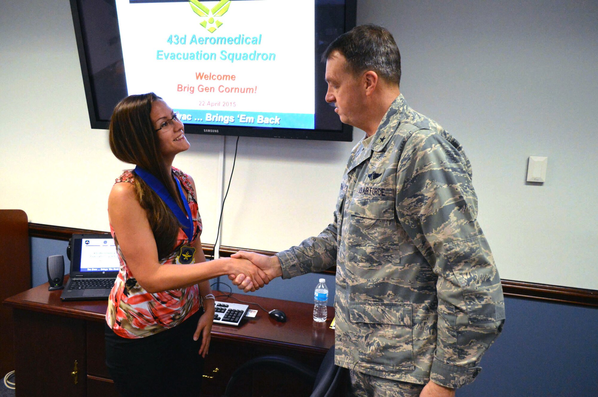 Brig. Gen. Kory Cornum, Air Mobility Command surgeon, presents the Air Mobility Command ‘Real Pro’ Award to Angela Morganthal, 43rd Aeromedical Evacuation Squadron, recognizing Morganthal’s outstanding duty performance during his visit to the 43rd Airlift Group on Apr. 22, Pope Army Airfield, N.C. (U.S. Air Force photo/Marvin Krause)