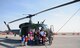 Team Malmstrom families pose in front of a UH-1N Huey during a static display April 22, 2015, at Malmstrom Air Force Base, Mont. Malmstrom Family Child Care, in conjunction with the 40th Helicopter Squadron, hosted the event to teach children more about the helicopter. (U.S. Air Force photo/Airman 1st Class Dillon Johnston)