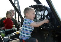 Team Malmstrom children explore a UH-1N Huey during a static display April 22, 2015, at Malmstrom Air Force Base, Mont. Malmstrom Family Child Care, in conjunction with the 40th Helicopter Squadron, hosted the event to teach children more about the helicopter. (U.S. Air Force photo/Airman 1st Class Dillon Johnston)