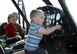 Team Malmstrom children explore a UH-1N Huey during a static display April 22, 2015, at Malmstrom Air Force Base, Mont. Malmstrom Family Child Care, in conjunction with the 40th Helicopter Squadron, hosted the event to teach children more about the helicopter. (U.S. Air Force photo/Airman 1st Class Dillon Johnston)
