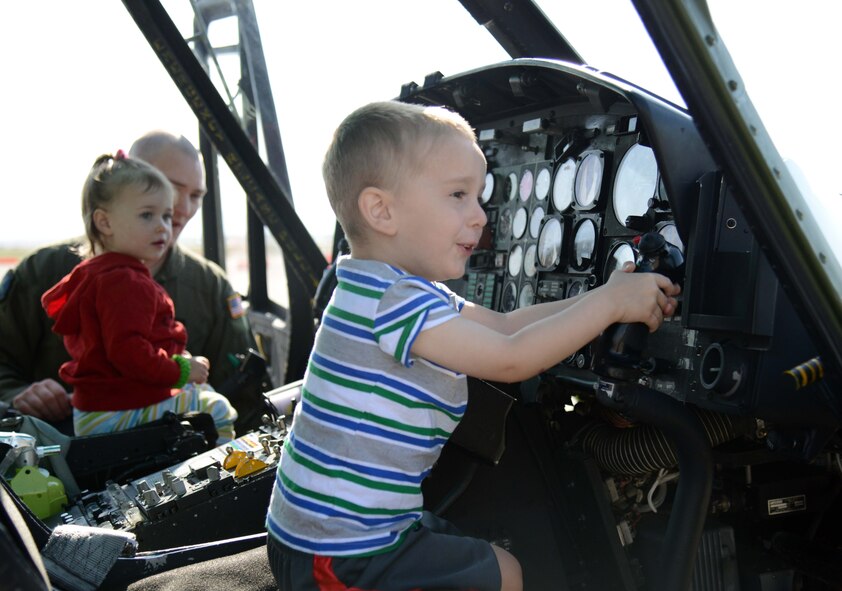 Team Malmstrom children explore a UH-1N Huey during a static display April 22, 2015, at Malmstrom Air Force Base, Mont. Malmstrom Family Child Care, in conjunction with the 40th Helicopter Squadron, hosted the event to teach children more about the helicopter. (U.S. Air Force photo/Airman 1st Class Dillon Johnston)