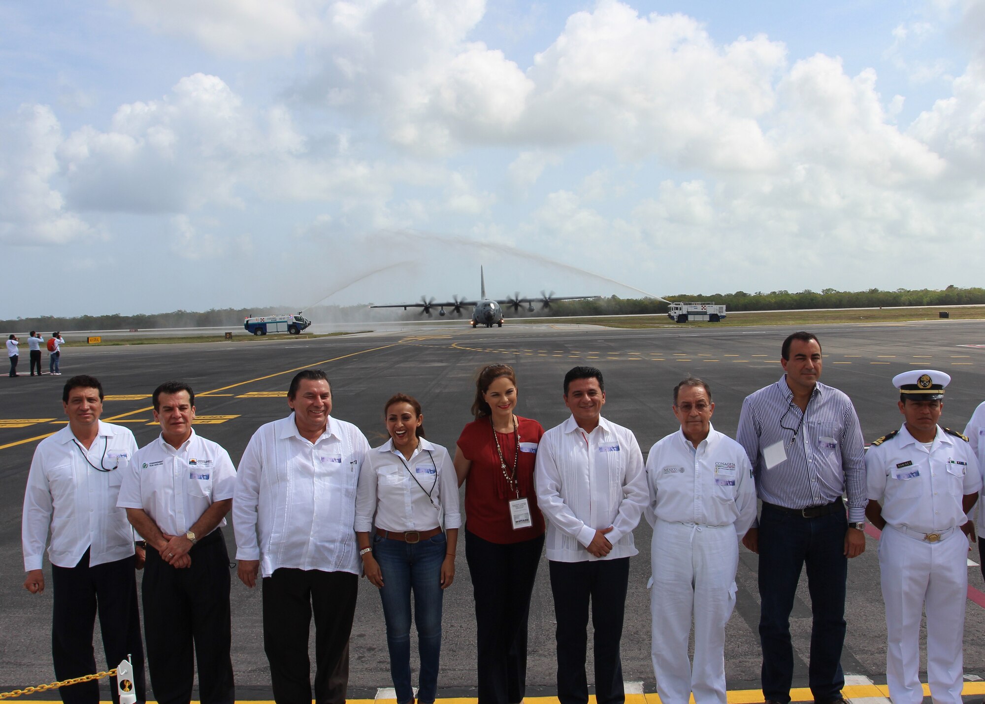 Mexican dignitaries pose for a photo as a 403rd Wing WC-130J arrives at Cozumel, Mexico, April 22, 2015 as part of the Caribbean Hurricane Awareness Tour. The outreach program, which began in the 1970's and is a joint effort between National Oceanic and Atmospheric Administration's National Hurricane Center and the 403rd Wing's 53rd Weather Reconnaissance Squadron, promotes hurricane awareness and preparedness throughout the Caribbean region. (Courtesy photo)