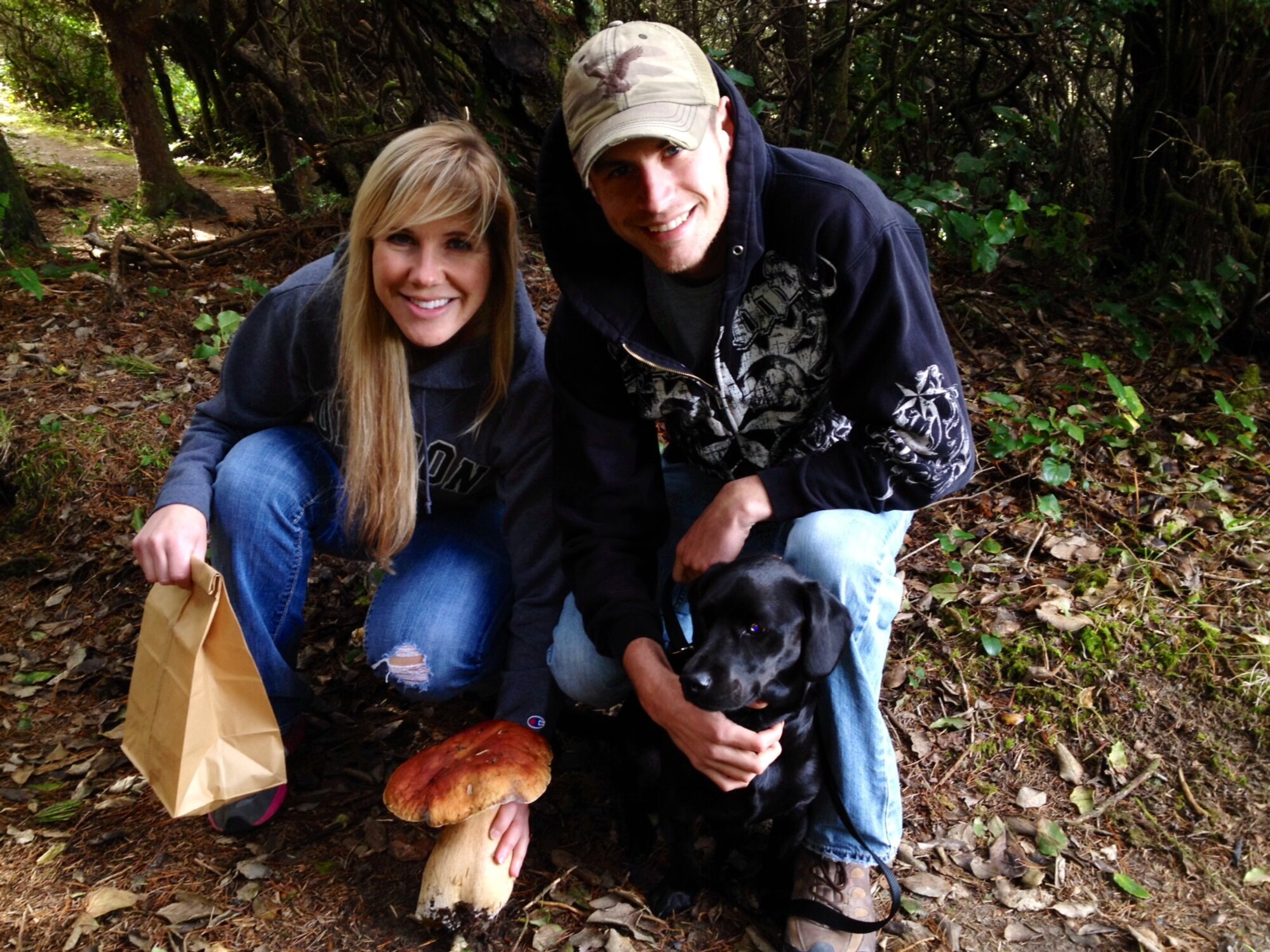 Staff Sgt. Benjamin Vanney, 366th Security Forces Squadron working dog handler, his wife, Emma, and their dog, Mushaka, pose during a hiking in Florence, Ore. Ever since he was a child, Vanney always had a passion for dogs and says he enjoys every minute of working as a dog handler. (Courtesy photo)