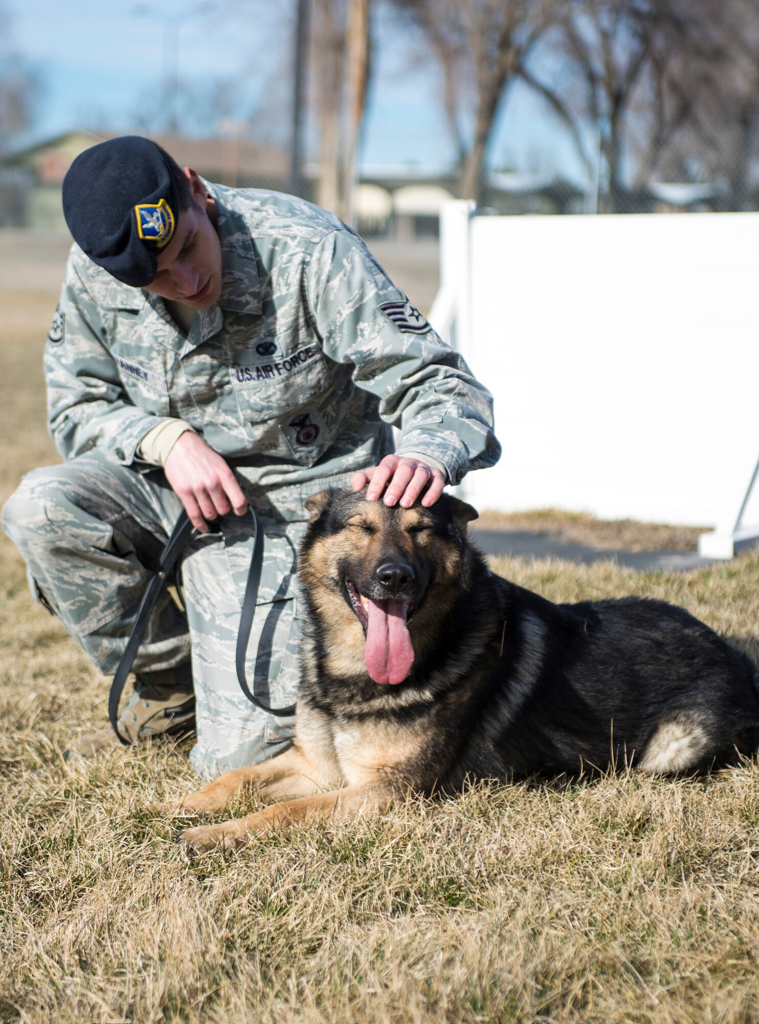Staff Sgt. Benjamin Vanney, 366th Security Forces Squadron military working dog handler, sits with Rony Feb. 24, 2015, at Mountain Home Air Force Base, Idaho. By playing, Ronny and Vanney have formed a bond which is a crucial part of the military working dog team. (U.S. Air Force photo by Senior Airman Malissa Lott/RELEASED)