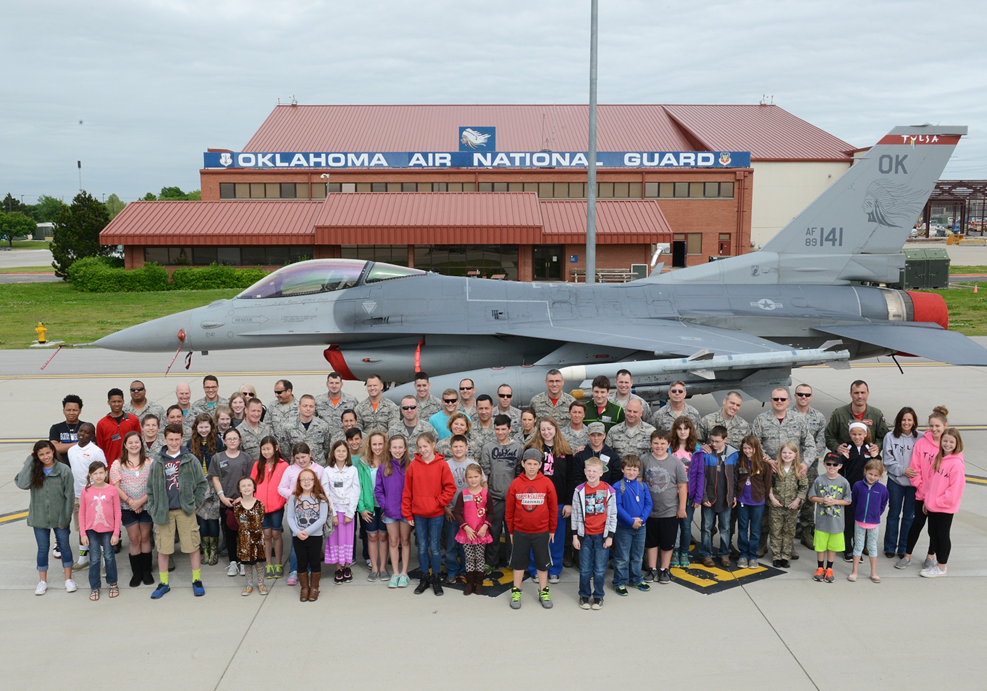 Parents and children pose for a group photo at the Tulsa Air National Guard Base, Okla., 23 April, 2015, during "National Take Our Daughters and Sons to Work Day."   The 138th participated in the event as a way to give children an insight into what their parents do, as well as demonstrating to them what is involved day to day in a job or career.  (U.S. National Guard photo by Senior Master Sgt.  Preston L. Chasteen/Released)