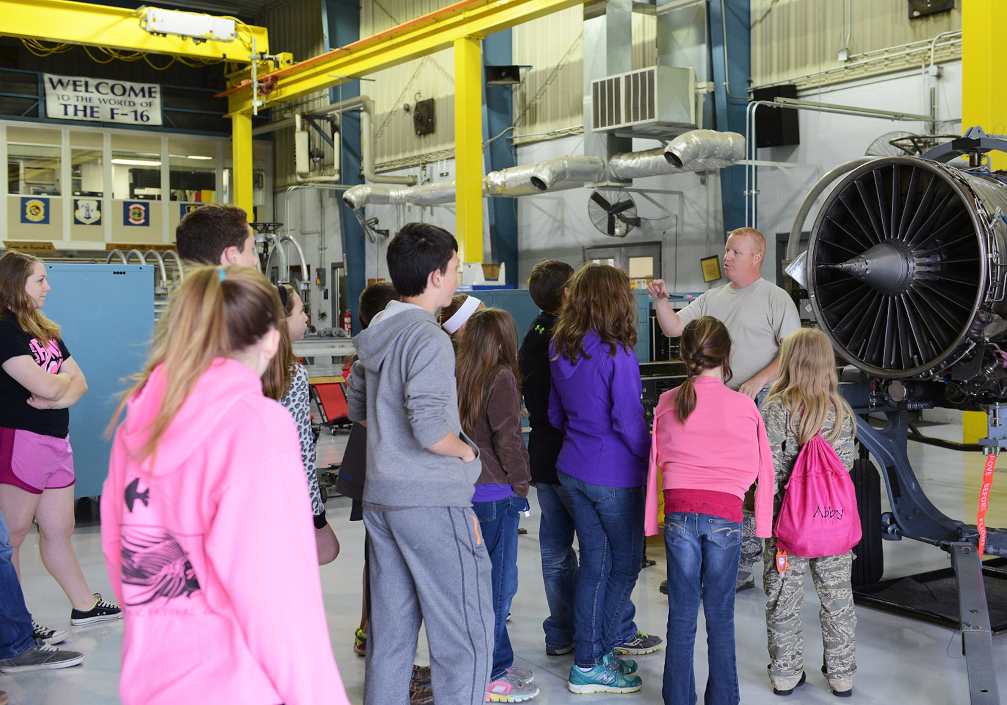 Tech. Sgt. Chad Patterson, 138th Maintenance Squadron, speaks with visiting children at the Tulsa Air National Guard Base, Okla., 23 April, 2015, during "National Take Our Daughters and Sons to Work Day."   The 138th participated in the event as a way to give children an insight into what their parents do, as well as demonstrating to them what is involved day to day in a job or career.  (Photo courtesy of Mrs. Wendy Burgy)