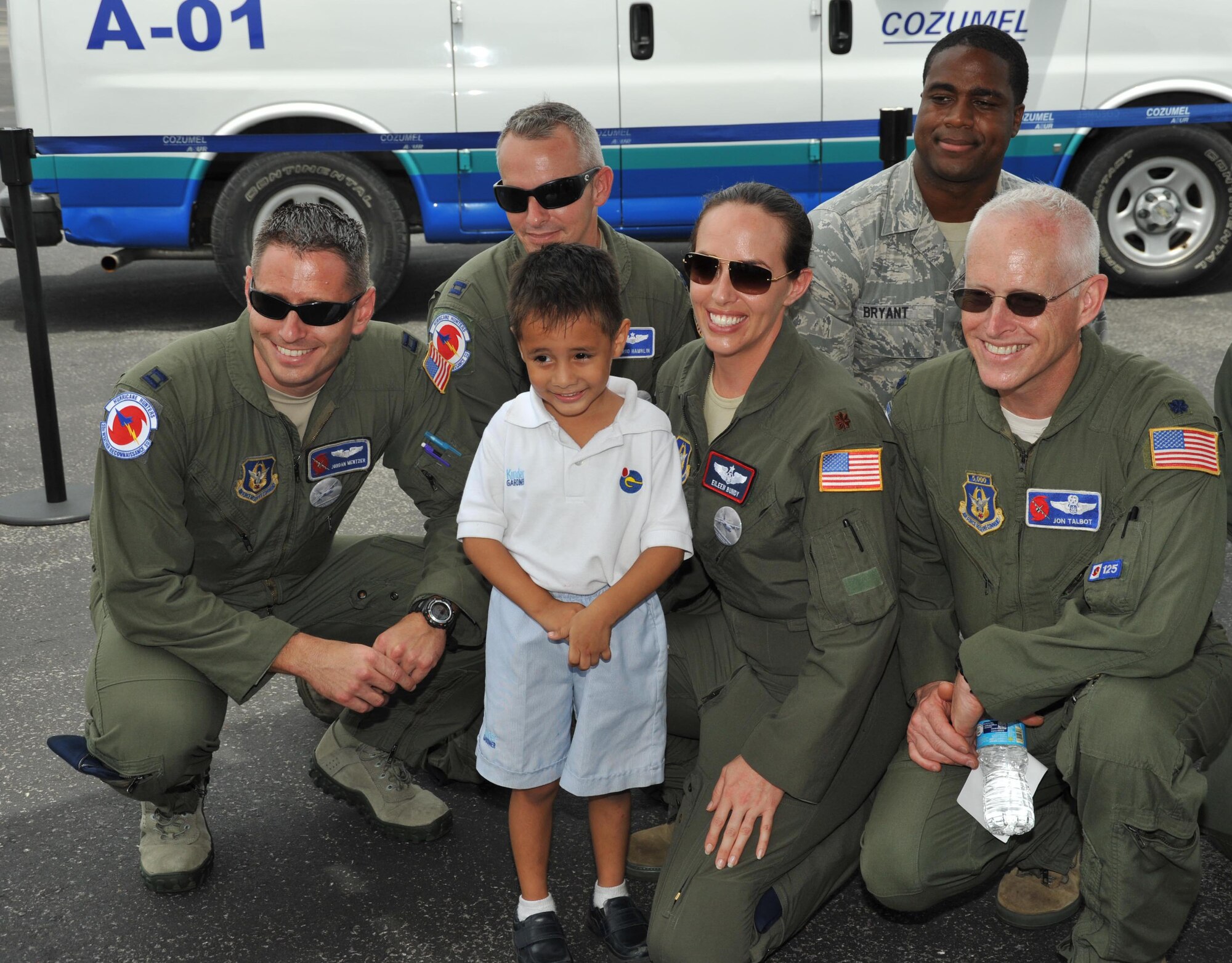 A little Hurricane Hunter fan from Cozumel, Mexico, poses with 53rd Weather Reconnaissance Squadron members Capt. Jordan Metzer, pilot, Capt. Jared Hamlin, pilot, Maj. Eileen Bundy, aerial reconnaissance weather officer, Lt. Col. Jon Talbot, chief ARWO, and Senior Airman Gary Bryant, 403rd Aircraft Maintenance Squadron crewchief. More than 500 locals toured the WC-130J, which was on display as part of the CHAT. The outreach program, which began in the 1970's and is a joint effort between National Oceanic and Atmospheric Administration's National Hurricane Center and the 403rd Wing's 53rd Weather Reconnaissance Squadron, promotes hurricane awareness and preparedness throughout the Caribbean region. (U.S. Air Force photo/Maj. Marnee A.C. Losurdo)