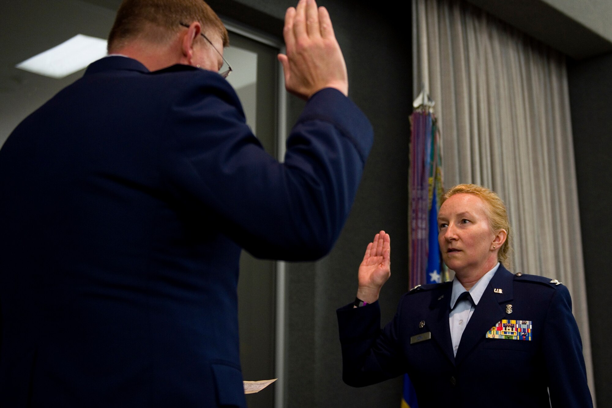 Col. Douglas Schwartz, 434th Air Refueling Wing commander, left, administers the oath of office to Col. Therese Kern, 434th Aerospace Medicine Squadron commander, during Kern's promotion ceremony at Grissom Air Reserve Base, Ind., April 12, 2015. Kern came to Grissom July 2013, serving as chief nurse, and took over command of the 434th AMDS April 2014. (U.S. Air Force photo/Tech. Sgt. Benjamin Mota)