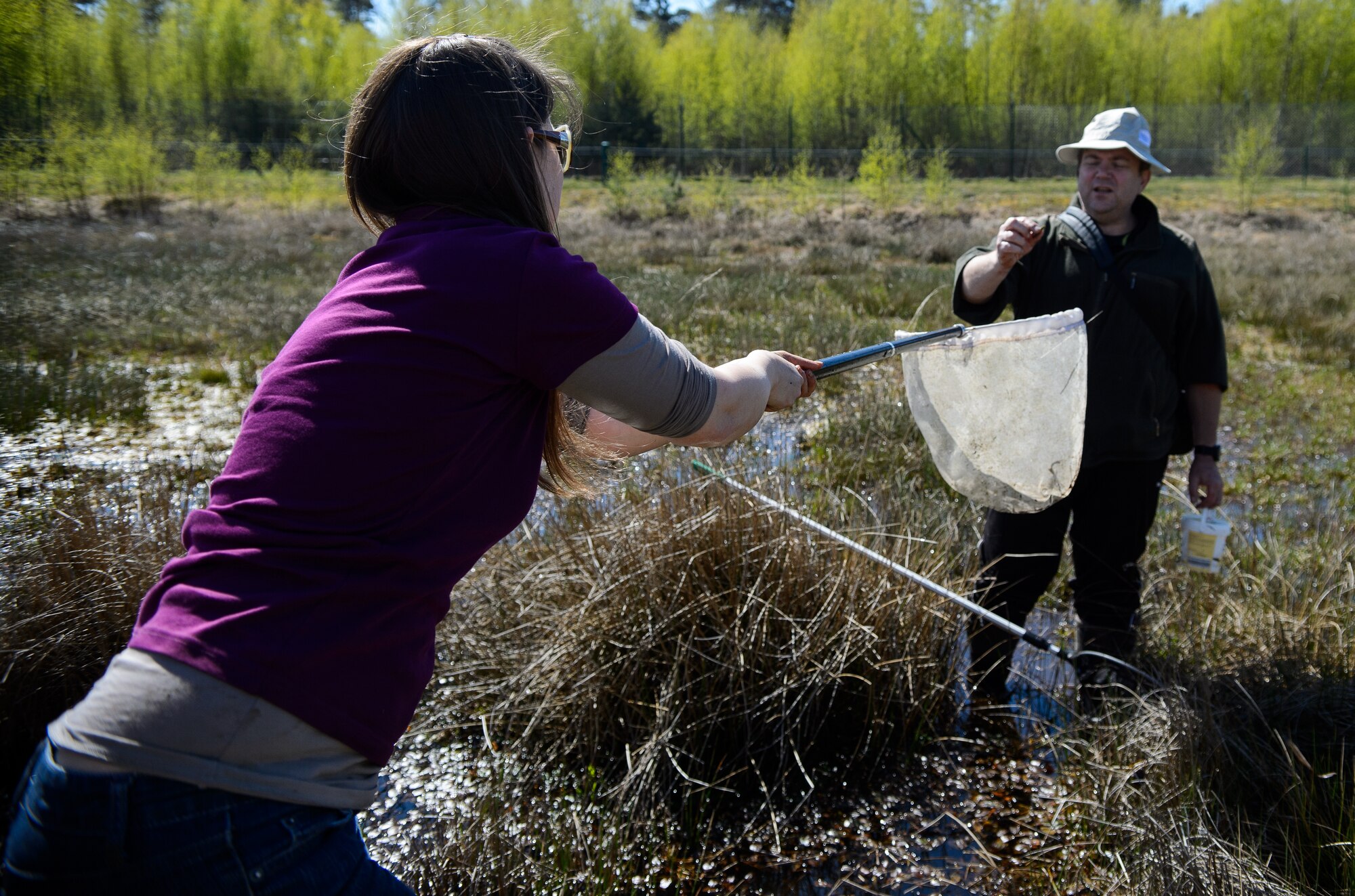 Susanne Panzer, 86th Civil Engineer Squadron natural scientist and biological geographer, receives a larva from Jürgen Ott, doctor of biology, April 22, 2015, at Ramstein Air Base, Germany. Panzer and Ott conduct regular surveys of Ramstein’s wetlands and wildlife to inventory and study the impact of the Ramstein mission on the environment. (U.S. Air Force photo/Staff Sgt. Armando A. Schwier-Morales)