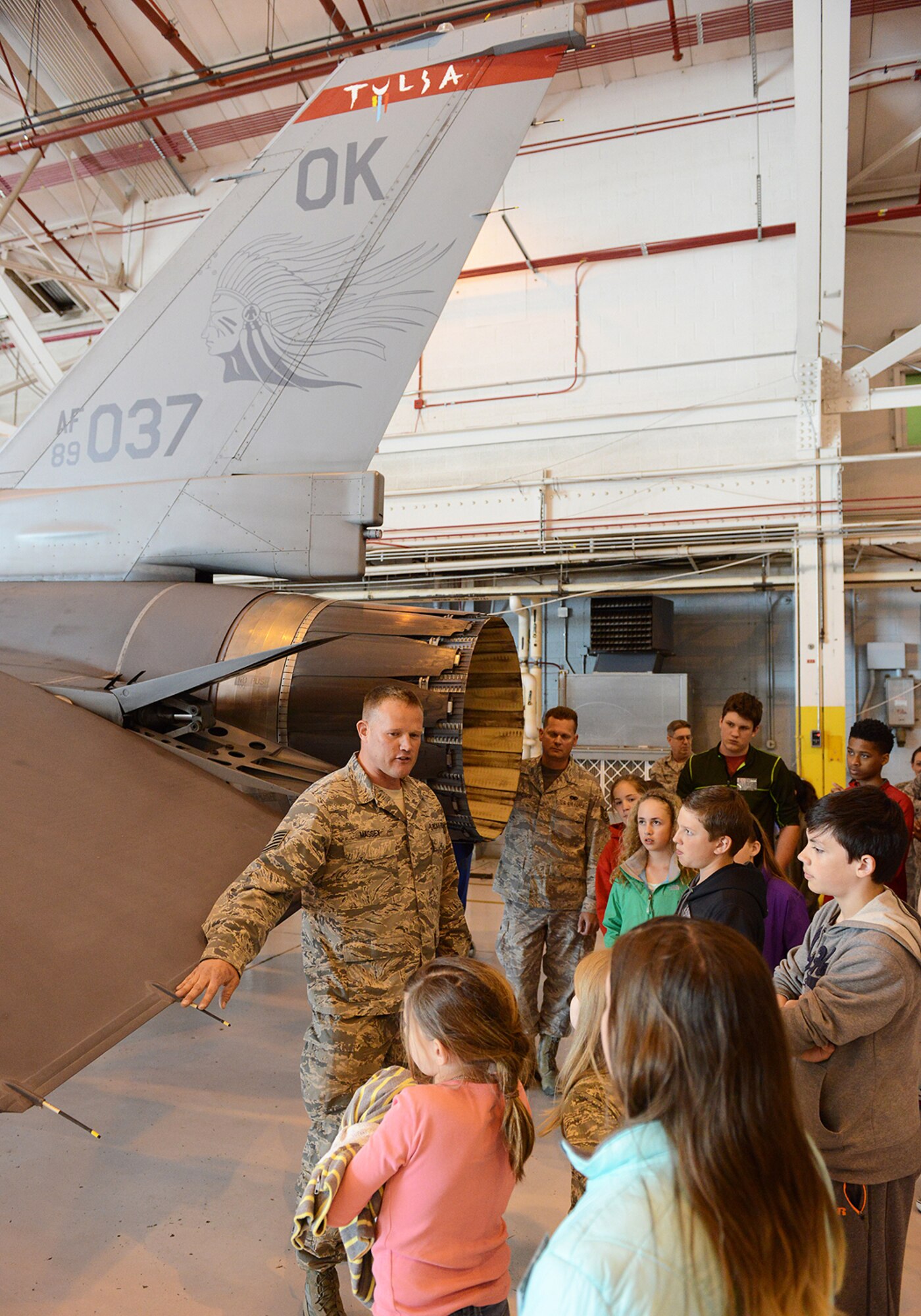 Tech. Sgt. Brian Massey, 138th Aircraft Maintenance Squadron, talks to visiting children about the capabilities of the F-16 at the Tulsa Air National Guard Base, Okla., 23 April, 2015, during "National Take Our Daughters and Sons to Work Day".   The 138th participated in the event as a way to give children an insight into what their parents do, as well as demonstrating to them what is involved day to day in a job or career.  (U.S. National Guard photo by Senior Master Sgt.  Preston L. Chasteen/Released)