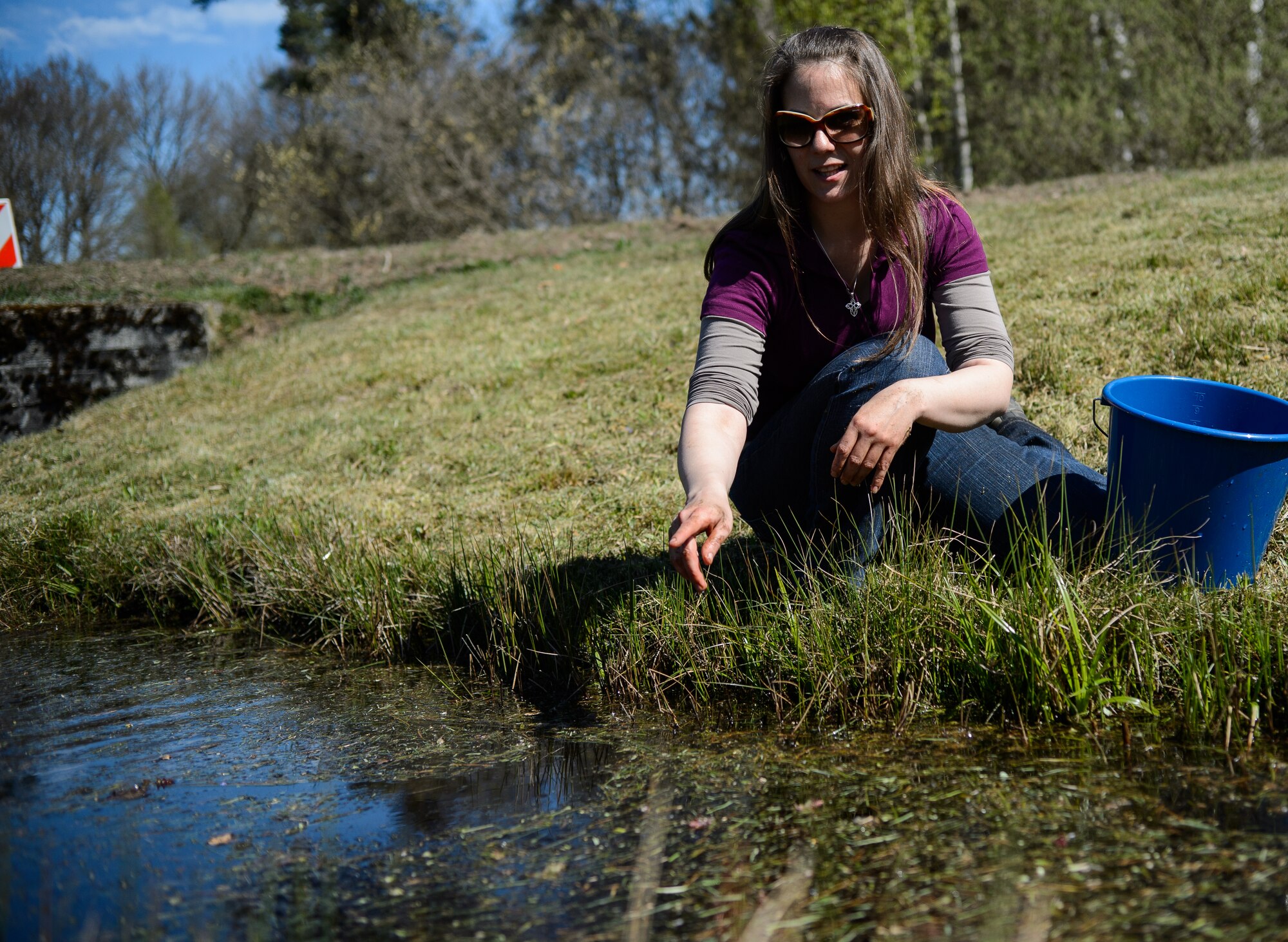 Susanne Panzer, 86th Civil Engineer Squadron natural scientist and biological geographer, points at the location of a recently released frog April 22, 2015, at Ramstein Air Base, Germany. Panzer and her team release the wildlife they find after examining and documenting their locations. (U.S. Air Force photo/Staff Sgt. Armando A. Schwier-Morales) 