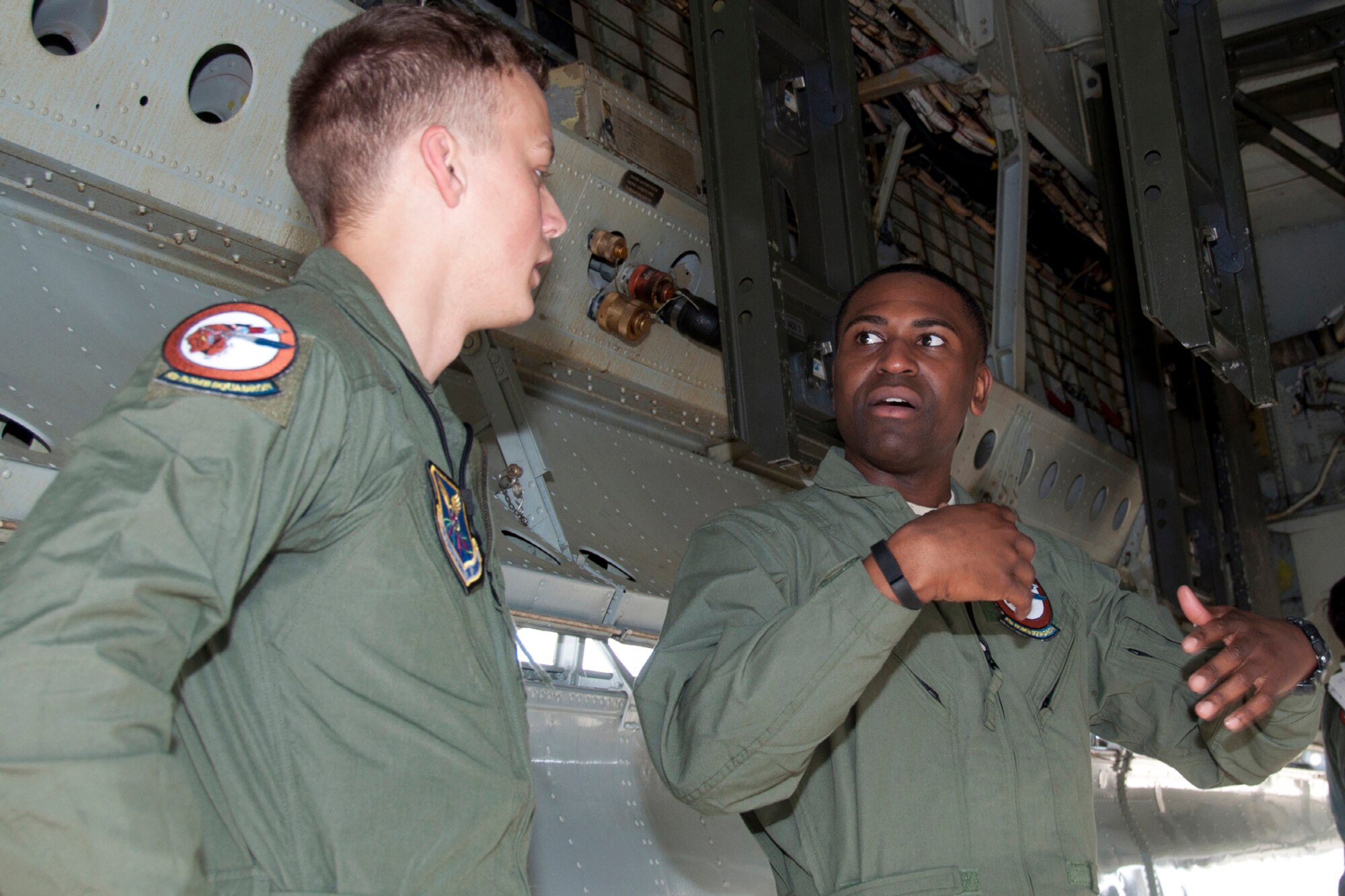 U.S. Air Force Senior Airman Joseph Caine, 2nd Bomb Wing hydraulics technician, and Senior Airman Joseph Moore, 307th Bomb Wing aerospace ground equipment technician, discuss the inner workings of a B-52 Stratofortress at Barksdale Air Force Base, La., April 26, 2015. Moore earned a flight on the jet by being named the 2014 Airmen of the Year for the wing.  (U.S. Air Force photo by Tech. Sgt. Ted Daigle/released)