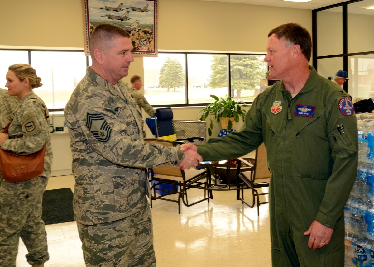 Chief Master Sgt. Sean Applegate, Army & Air Force Exchange Service's senior enlisted advisor is welcomed by Col. Russ Walz, 114th Fighter Wing commander, during his visit to the Sioux Falls Exchange April 24, 2015.  Applegate toured the Exchange facility and met with Airmen to address how the Exchange can better serve them. (National Guard photo By Senior Airman Duane Duimstra/Released)