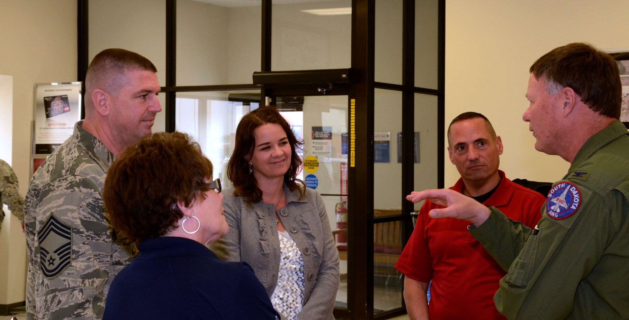 Chief Master Sgt. Sean Applegate, Army & Air Force Exchange Service's senior enlisted advisor, and Col. Russ Walz, 114th Fighter Wing commander, discuss the benefits of having the Sioux Falls Exchange at Joe Foss Field, S.D. April 24, 2015 . Applegate toured the Exchange facility and met with Airmen to address how the Exchange can better serve them. (National Guard photo By Senior Airman Duane Duimstra/Released)