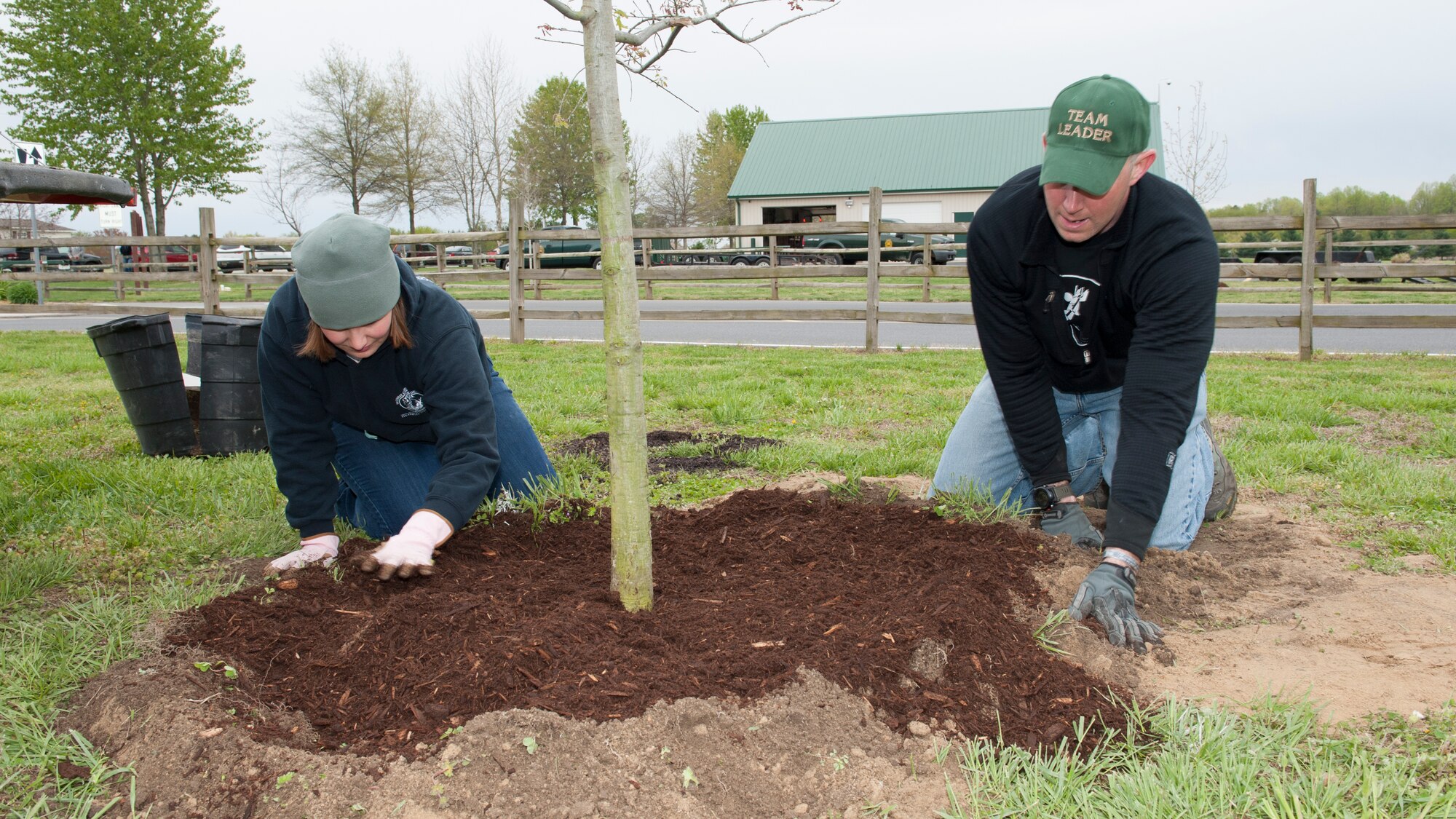 Staff Sgt. Elizabeth Morris, 436th Force Support Squadron First Term Airman Center team leader, and Staff Sgt. Clay Morris, 436th Operations Support Squadron NCO in charge of Aircrew Flight Equipment technician training, place mulch around a newly planted tree during a trail blazing and reforestation event April 25, 2015, at Browns Branch County Park in Harrington, Del. Clay worked as one of nine team leaders. (U.S. Air Force photo/Airman 1st Class Zachary Cacicia)