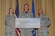 GOODFELLOW AIR FORCE BASE, Texas - Col. Kimberlee P. Joos, 17th Training Wing Commander, and Chief Master Sgt. Thomas F. Good, 17th TRW Command Chief, present Master Sgt. Brandon C. Welton, 17th Medical Group first sergeant, with the Team Goodfellow Permanent Party Dormitory of the Quarter award for building 242 during the wing quarterly awards ceremony at the base theater April 24. (U.S. Air Force photo/ Staff Sgt. Laura R. McFarlane)