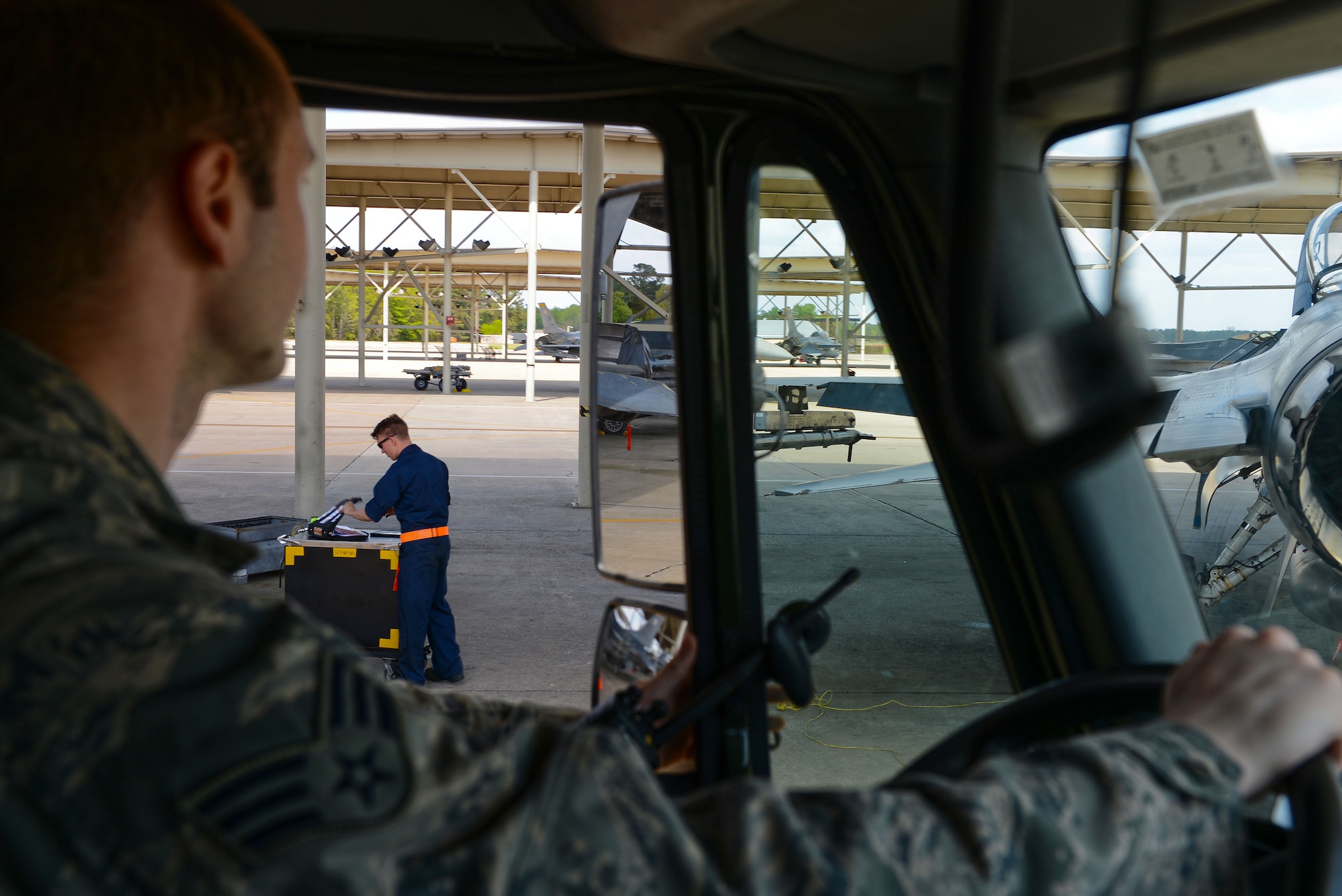 An Airman assigned to the 20th Logistics Readiness Squadron fuels management flight stops a fuel truck at behind and F-16CM Fighting Falcon at Shaw Air Force Base, S.C., April ,6 2015. The LRS fuels management flight Airmen have an approximate nine-minute response time to an F-16 after receiving an order for jet fuel. (U.S. Air Force photo by Senior Airman Jensen Stidham/Released)