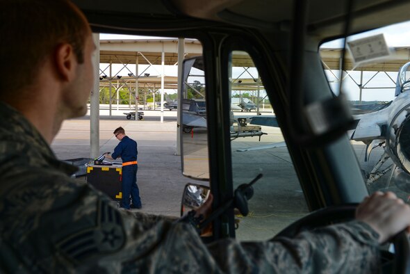 An Airman assigned to the 20th Logistics Readiness Squadron fuels management flight stops a fuel truck at behind and F-16CM Fighting Falcon at Shaw Air Force Base, S.C., April ,6 2015. The LRS fuels management flight Airmen have an approximate nine-minute response time to an F-16 after receiving an order for jet fuel. (U.S. Air Force photo by Senior Airman Jensen Stidham/Released)