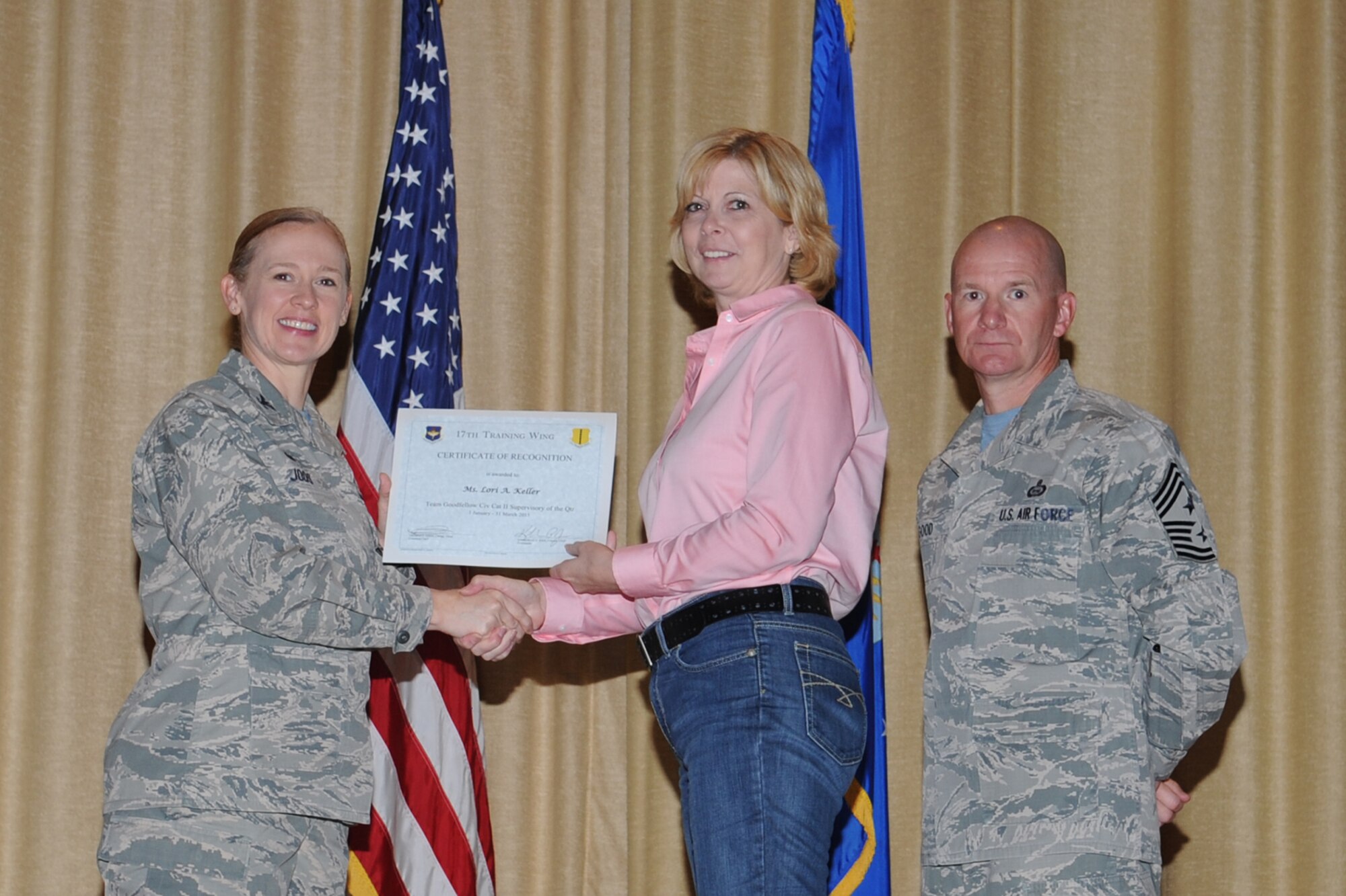 GOODFELLOW AIR FORCE BASE, Texas - Col. Kimberlee P. Joos, 17th Training Wing Commander, and Chief Master Sgt. Thomas F. Good, 17th TRW Command Chief, present the Team Goodfellow Civilian Category II Supervisory of the Quarter award to Lori A. Keller, 17th Mission Support Group, during the wing quarterly awards ceremony at the base theater April 24. Keller also received the 17th Training Wing Civilian Category II Supervisory of the Quarter award. (U.S. Air Force photo/ Staff Sgt. Laura R. McFarlane)