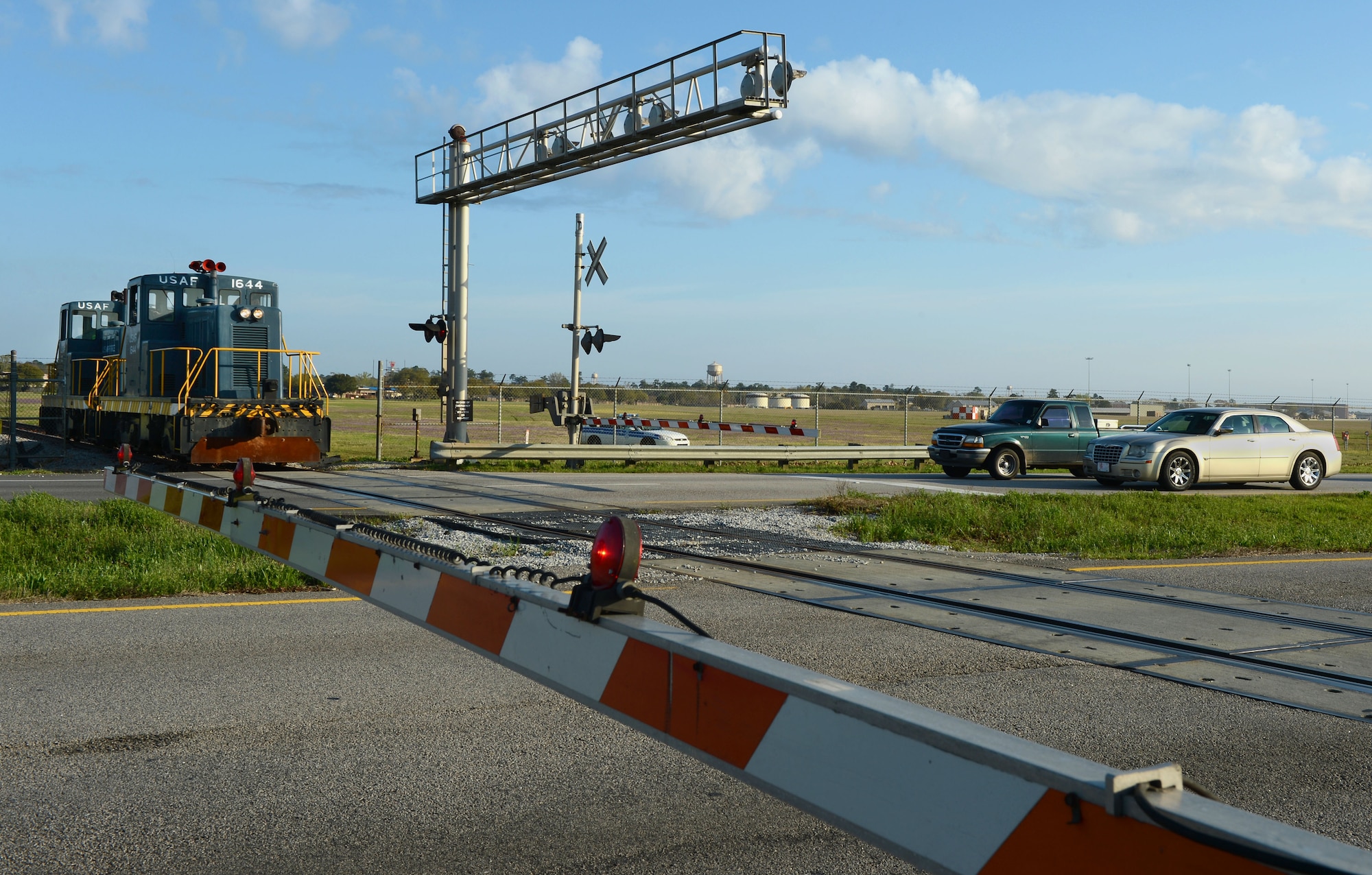 The 20th Logistics Readiness Squadron locomotive prepares to cross the road at Shaw Air Force Base, S.C., March 25, 2015. Operating approximately every two weeks, the train is used to pick-up jet fuel located off base. (U.S. Air Force photo by Senior Airman Jensen Stidham/Released)