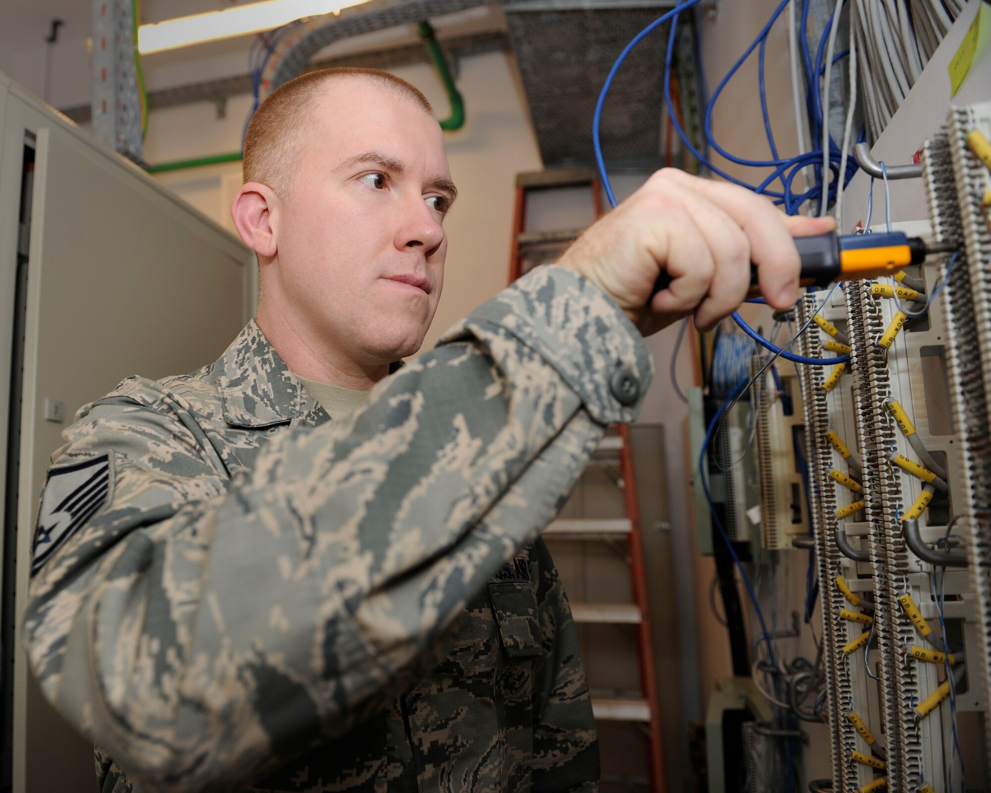Master Sgt. Kenneth Daugherty III, 39th Communications Squadron section chief, places a jumper to extend a phone number extension to a specific location April 23, 2015, at Incirlik Air Base, Turkey. Daugherty was one of two Airmen at the U.S. Air Forces in Europe - U.S. Air Forces Africa-level to be nominated for the Airlift/Tanker Association Young Leadership Awards due to his dedication and leadership. (U.S. Air Force photo by Senior Airman Krystal Ardrey/Released)