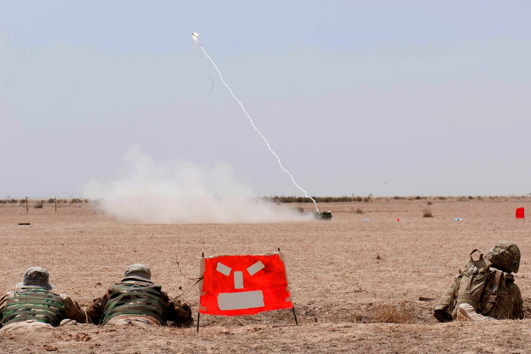 U.S. and Iraqi soldiers take cover as an anti-personnel obstacle breaching system fires during a breaching training exercise at Besmaya Range Complex, Iraq, April 18, 2015.