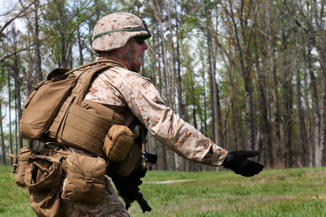 A Marine directs his squad to assault the next objective during an infantry platoon exercise on Fort Pickett, Va., April 17, 2015.
