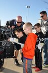 Firefighter Christopher Kail, assigned to the Air Force Reserve’s 910th Civil Engineer Fire Department, explains the winch on the front of a firefighting vehicle to a group of fans outside the Covelli Centre during pre-game festivities for a Youngstown Phantoms hockey game here, April 11, 2015. A group of Citizen Airmen, based at nearby Youngstown Air Reserve Station, Ohio, participated in YARS Night Out activities before and during the game including a static display of 910th CEF vehicles. Prior to the game, the Phantoms, a member of the United States Hockey League, were presented the league’s Anderson Trophy for achieving the most points by a team this season. The Phantoms defeated Team USA 7-1 to complete their regular season in front of a home ice crowd of more than 4000 fans. (U.S. Air Force photo/ Master Sgt. Bob Barko Jr.)