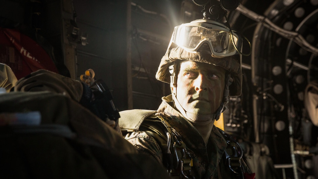A Marine with Bravo Company, 2nd Reconnaissance Battalion prepares to jump from a CH-53E Super Stallion helicopter at an altitude of 6,000 feet during a four-day certification exercise aboard Marine Corps Outlying Field Atlantic, N.C., April 23, 2015. Marines commenced the exercise performing inserts through helocasting and double-bag static lines to collect information on the objective. 