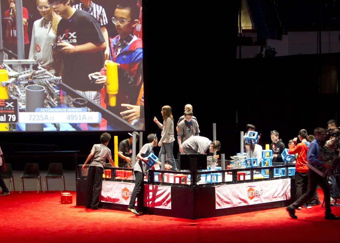 Students from Scott Middle School reset the competition field between robot battles at the VEX Robotics world championship.