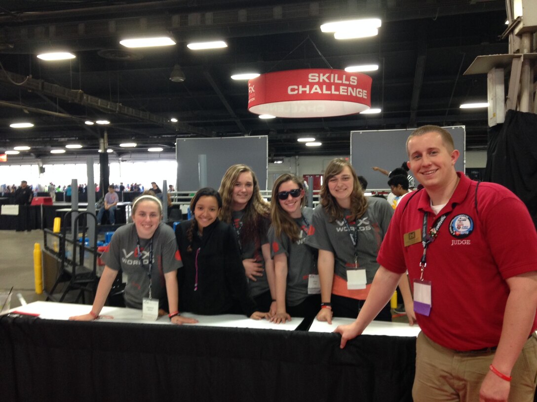 Along with many other Louisville District representatives, Corey White (right), environmental engineer, and students from Scott Middle School, Fort Knox, Ky., volunteered at the VEX Robotics world championship in Louisville.