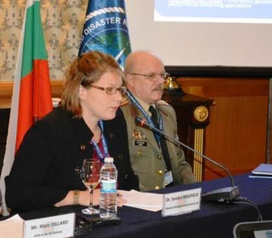 Col. Mitko Stoykov, director of NATO Crisis Management and Disaster Response Centre of Excellence, right, directed the question and answer session for EL’s Dr. Sandra Brasfield at the Dec. 11 technology demonstration for the European Command (EUCOM) and EUCOM Defense Environmental International Cooperation program conference in Sofia, Bulgaria. 