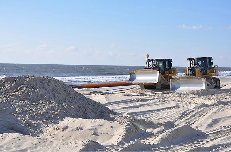 Bulldozers distribute newly-placed sand on Westhampton Beach, N.Y., Nov. 21, 2014. The sand, pumped onto the beach from an approved-offshore borrow site, repaired severe erosion caused by Hurricane Sandy in 2012.