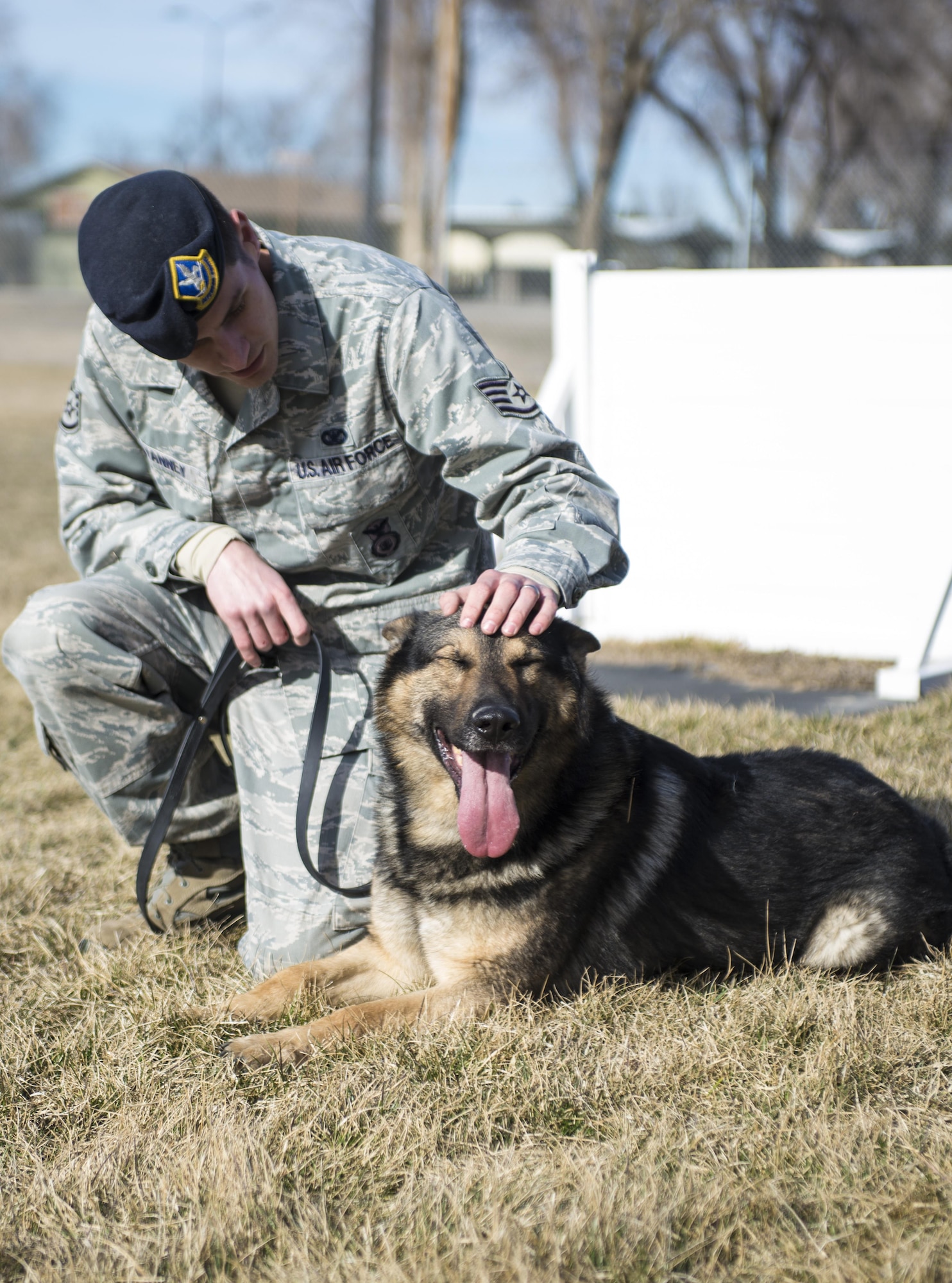 Staff Sgt. Benjamin Vanney, a 366th Security Forces Squadron military working dog (MWD) handler, sits with Rony Feb. 24, 2015, at Mountain Home Air Force Base, Idaho. By playing, Ronny and Vanney have formed a bond which is a crucial part of the MWD team. (U.S. Air Force photo/Senior Airman Malissa Lott)
