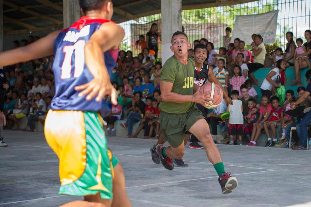 An Armed Forces of the Philippines Army basketball player aims for a layup at a friendly basketball game between Barangay Taft basketball players and players from the Combined-Joint Civil-Military Operations Task Force on the island of Panay in Tapaz, Philippines, during Balikatan 2015, April 28. The goodwill game was held for some fun and entertainment following the conclusion of the combined U.S. and AFP force’s humanitarian and disaster response activities on the island. Balikatan, which means “shoulder to shoulder” in Filipino, is an annual bilateral training exercise aimed at improving the ability of Philippine and U.S. military forces to work together during planning, humanitarian assistance and disaster relief operations.