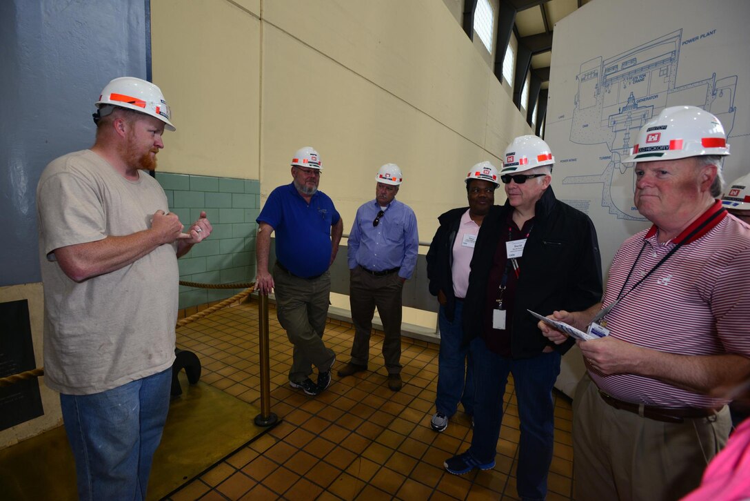 Nicholas Pilcher, a hydropower trainee, from the Old Hickory power plant, explains to the Federal Utility Partnership Working group the process of water flow and generator operations at the Old Hickory Dam in Hendersonville, Tenn., April 23, 2015.